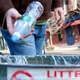 A local resident discards a plastic bottle—just as he has done his whole life—with no perceivable effect on the environment.